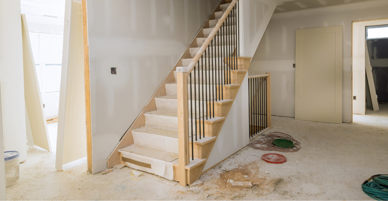 An unfinished staircase leading to a basement.
