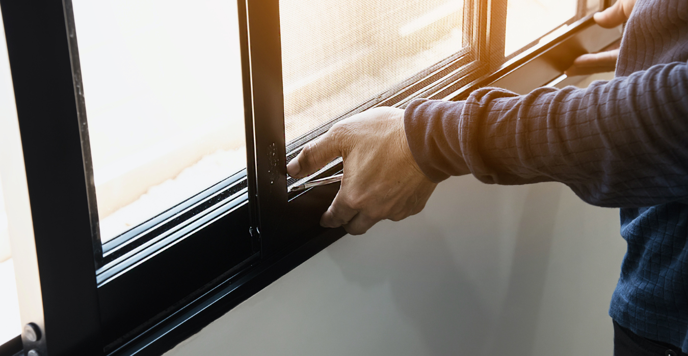 Person closing window of house.